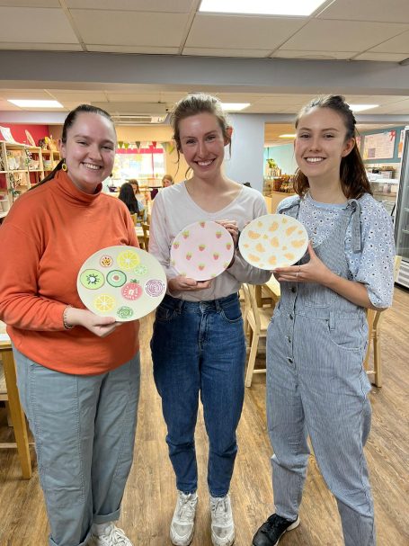 Reading Rooks girls at socials Reading Rooks women's korfball members showing off their painted pottery at a club social event