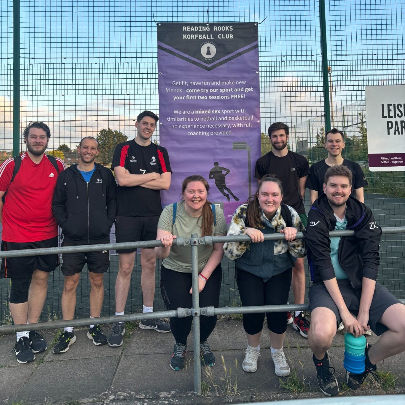 Reading Rooks members posing in front of a promotional poster