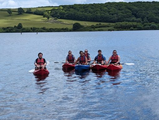 Club Members Kayaking on a lake